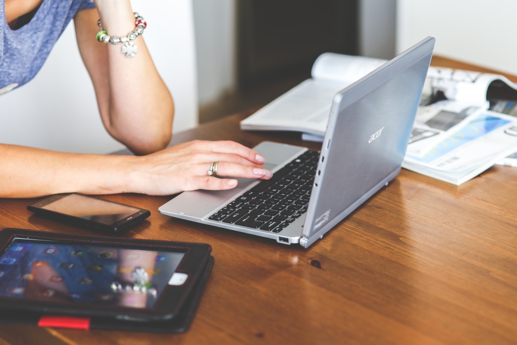 Woman typing on a laptop at a desk